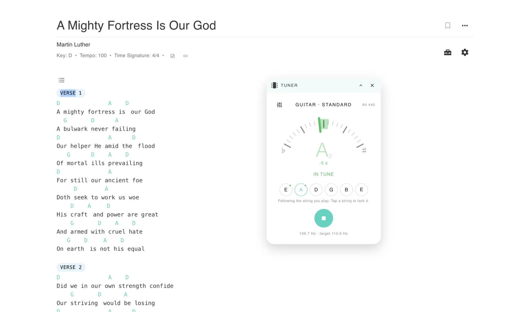 The Song7 tuner open beside a chord chart for A Mighty Fortress Is Our God, reading A2 at 5 cents flat, with the low E and A strings marked as done